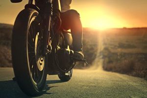 On a roaring motorcycle at sunset | When Poor Road Conditions Cause a Motorcycle Accident
