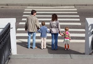 family about to enter crosswalk while holding hands | Auto-Pedestrian Accidents Involving Children