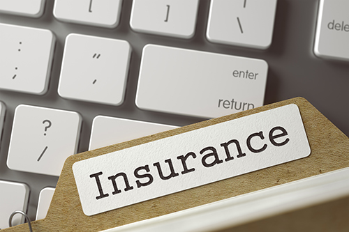 insurance file on keyboard Rising Cost of Car Insurance