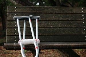 pair of crutches leaning against bench | Car Accident Related Knee Injuries 