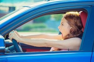 female driver in blue car yelling | Aggressive Driving Accident Attorney