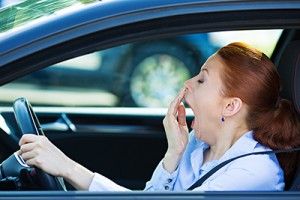 woman yawning while behind the wheel | Driver Fatigue Car Accidents