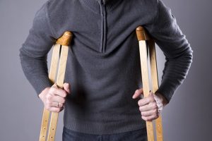 Man on crutches | 3 Mistakes That Could Ruin Your PI Case